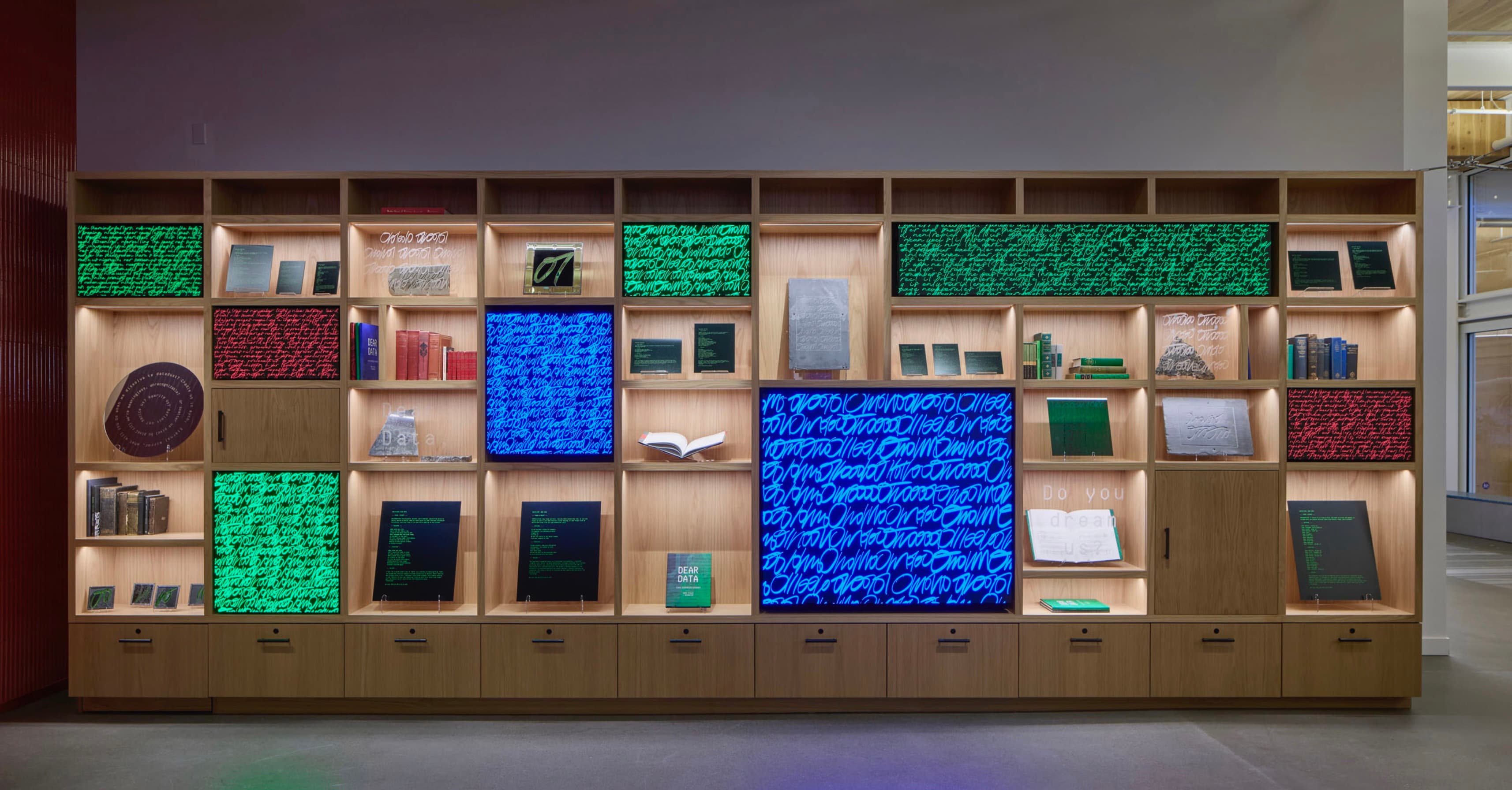 DEAR Data installation arranged in illuminated shelving at Gradient Canvas