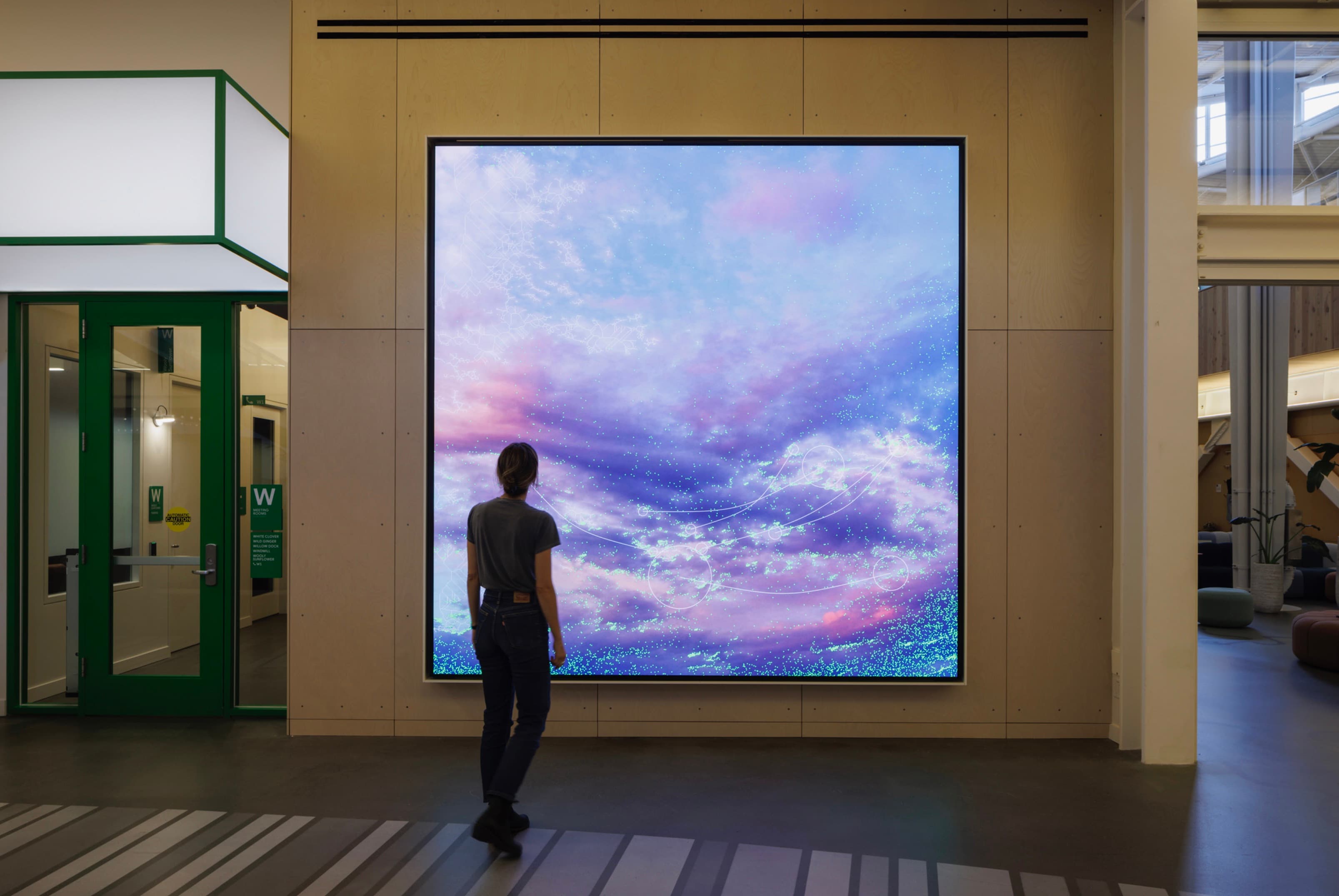 Clouds artwork displayed in Gradient Canopy with a visitor approaching